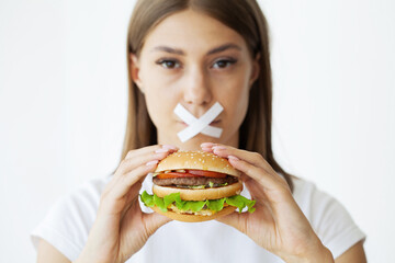 Slimming concept, young woman with sealed mouth giving up junk food