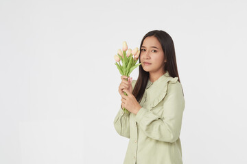 Spring Beautiful cheerful girl smiling and holding a bouquet of tulip flowers. Young happy woman. Surprise at the 8 March International Women's Day.