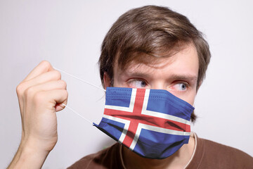 Young Icelandic man wearing Iceland face mask during coronavirus pandemic