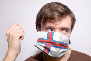 Young Faroese man wearing Faroe Islands face mask during coronavirus pandemic