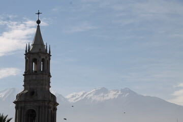 Fototapeta na wymiar Church with snow-capped mountain in the background.
