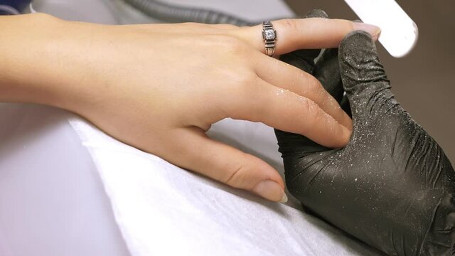 Manicure process. Correction of female nails with nailfile