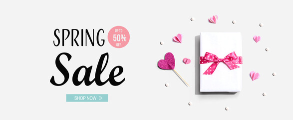 Spring sale message with a gift box and paper hearts