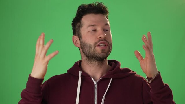 Close up head shot portrait man applicant on green screen chroma key wave hand greeting remote employer hr managers answers questions feels confident during job interview by video call app concept
