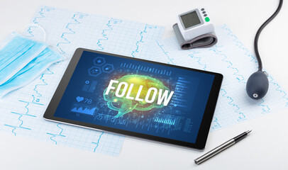 Tablet pc and medical tools with FOLLOW inscription, social distancing concept
