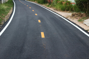 Fototapeta na wymiar black asphalt winding road transport with white and yellow line