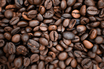 Roasted coffee beans background in warm tones