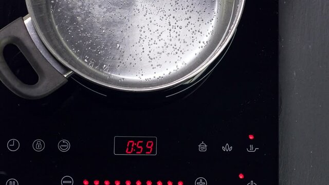 Boiling water in metal pan, closeup. Top View