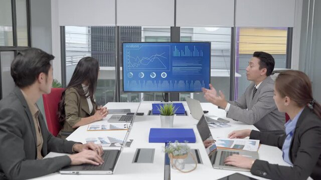 The supervisor of the business team is presenting operation of machines in meeting rooms within offices
