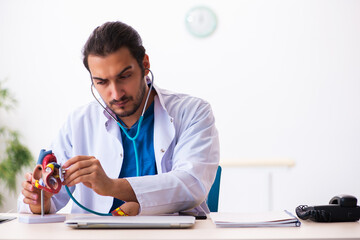 Young male doctor cardiologist working in the clinic