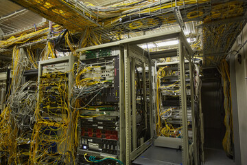 Wide angle background image of server room with internet cables and wires, copy space