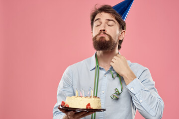 Bearded man with cake on pink background birthday party corporate emotions model loneliness