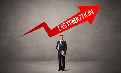 Fototapeta premium Young business person in casual holding road sign with DISTRIBUTION inscription, business direction concept