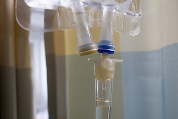 Bag of intravenous fluid drips. infuses saline and other injected drugs into patient in hospital room.