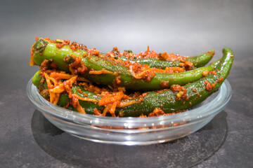 Korean kimchi green chili stuffed with carrots, green onions, garlic, fermented vegetables.