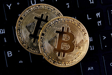 bitcoin is place on the keyboard of the laptop, cryptocurrency trading technology concept.