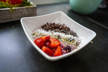  An organic, vegan, gluten-free, plant-based, oatmeal breakfast with strawberries, steel-cut oats, hemp hearts, chia seeds, oat milk, berries, coconut, cacao nibs