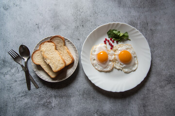 Bread slices and egg poaches are a popular breakfast ingredient. Top view, selective focus.