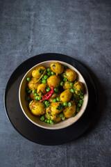 Indian dum aloo or potatoes cooked in slow fire in a bowl. Close up, selective focus.