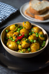 Indian dum aloo or potatoes, a spicy dish in a bowl. Close up, selective focus.