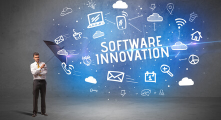 Businessman defending with umbrella from SOFTWARE INNOVATION inscription, modern technology concept