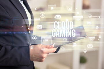 Close-up of a tablet searching CLOUD GAMING inscription, modern technology concept