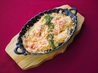 Beefsteak with tomato and herbs on a red background
