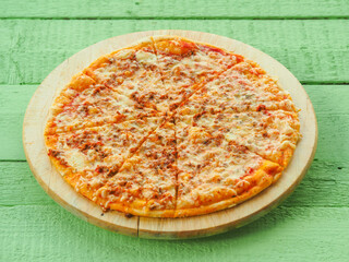 pizza on a wooden green background. Italian kitchen