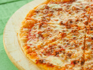 pizza on a wooden green background. Italian kitchen