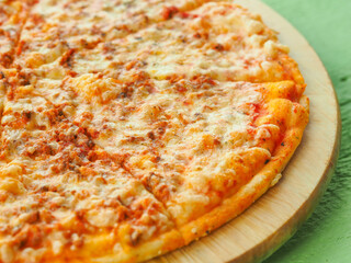 pizza on a wooden green background. Italian kitchen