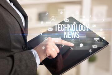 Close-up of a tablet searching TECHNOLOGY NEWS inscription, modern technology concept