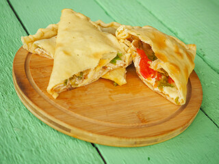 pie with tomatoes on a green wooden background