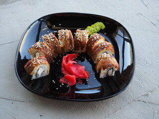 Japanese kitchen. Sushi and rolls on gray concrete background