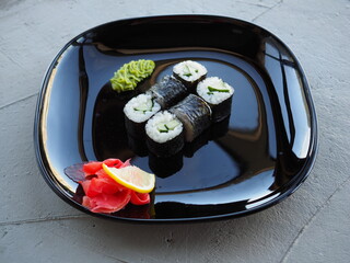Japanese kitchen. Sushi and rolls on gray concrete background