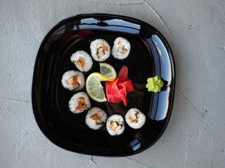 Japanese kitchen. Sushi and rolls on gray concrete background