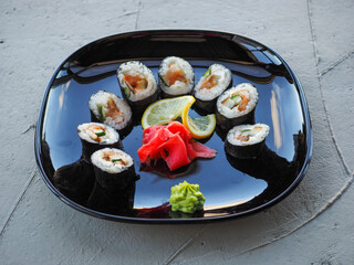 Japanese kitchen. Sushi and rolls on gray concrete background