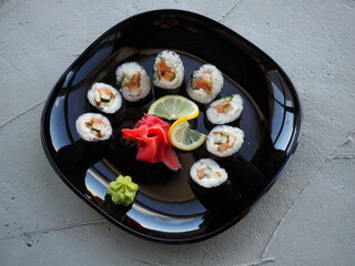 Japanese kitchen. Sushi and rolls on gray concrete background