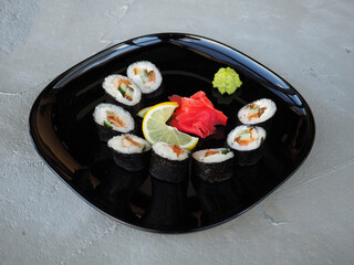 Japanese kitchen. Sushi and rolls on gray concrete background