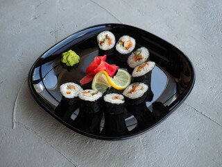 Japanese kitchen. Sushi and rolls on gray concrete background