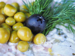Olivier salad on a blue wooden background