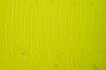Smears of transparent gel on green background. Hygiene, skincare product creamy texture.