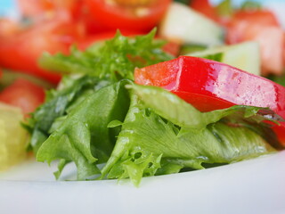 Salad with cucumber and tomato on a blue wooden background