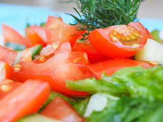 Salad with cucumber and tomato on a blue wooden background