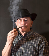 Cowboy in hat with Pipe