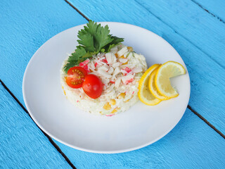 Olivier salad on a blue wooden background