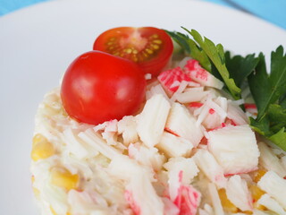 Olivier salad on a blue wooden background
