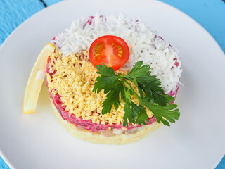 Salad with crab sticks on blue wooden background