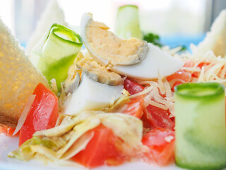 Salad with crab sticks on blue wooden background