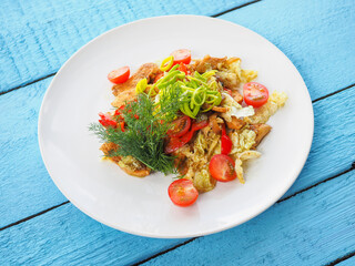 Chicken salad on blue wooden background