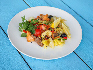 Chicken salad on blue wooden background